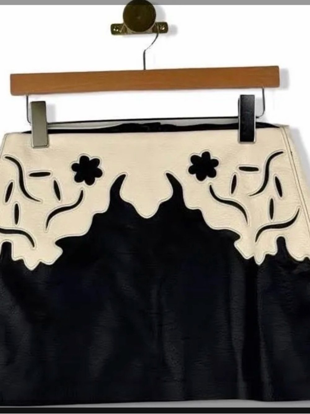 Blank NYC “Buckle Up” Vegan leather Mini skirt with Floral Cutouts